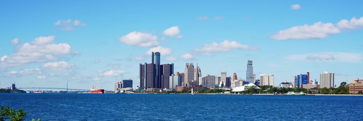 The Detroit, Michigan skyline across the blue water of the Detroit River