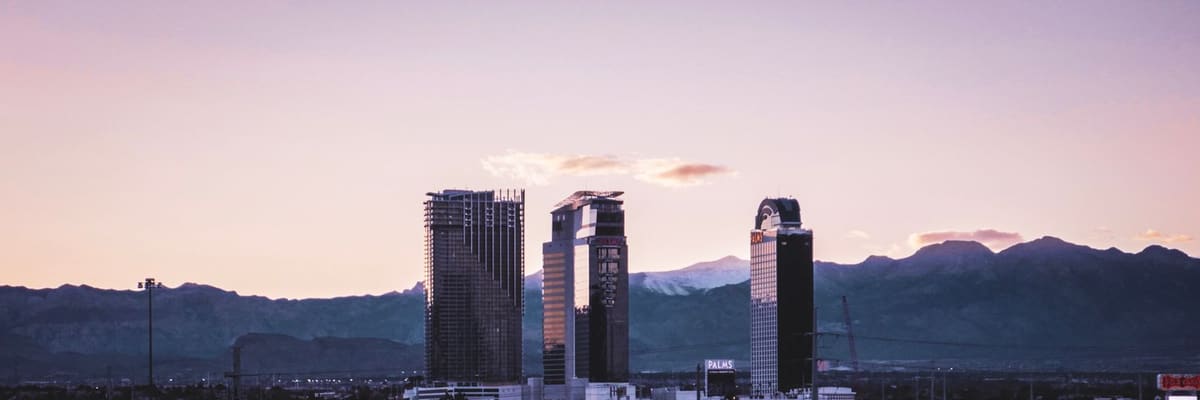 The Las Vegas, Nevada skyline against a mountain backdrop at dusk