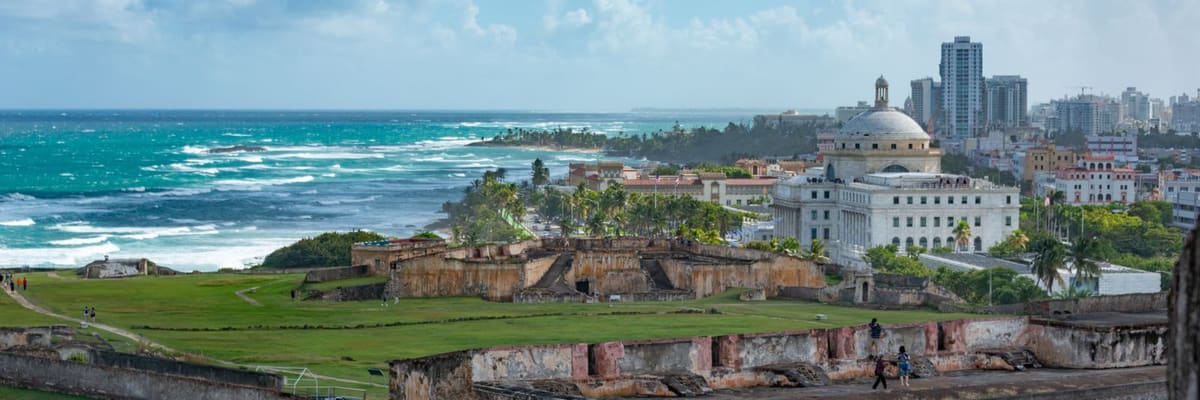 The historic fort of San Juan, Puerto Rico, beside the ocean under a vibrant sky