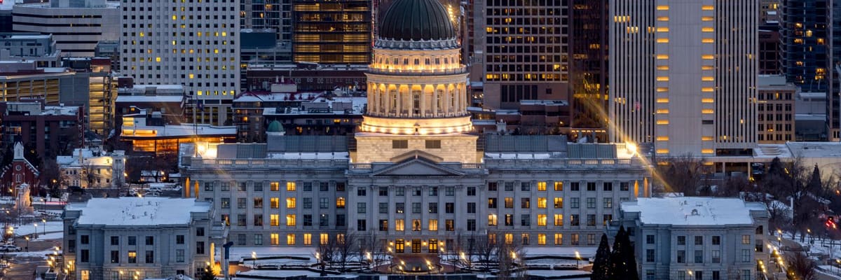 The Salt Lake City, Utah skyline in the evening, with the Utah State Capitol lit up